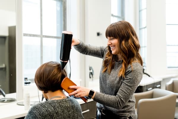 Stylist working with client at salon